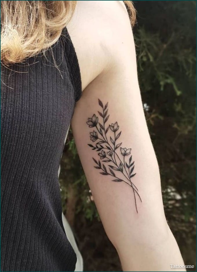 small flower inner bicep tattoos