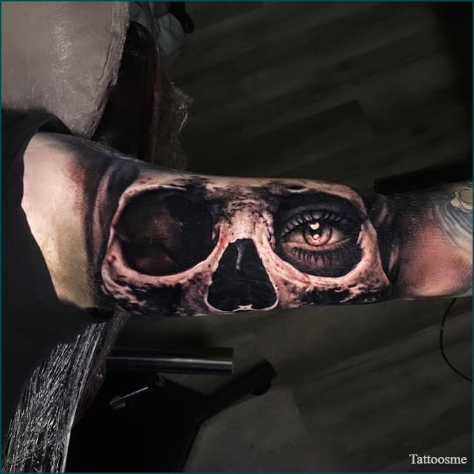 skull face inner bicep tattoo