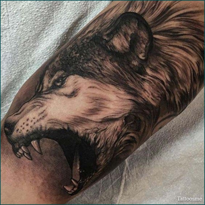 roaring wolf tattoo design on inner bicep