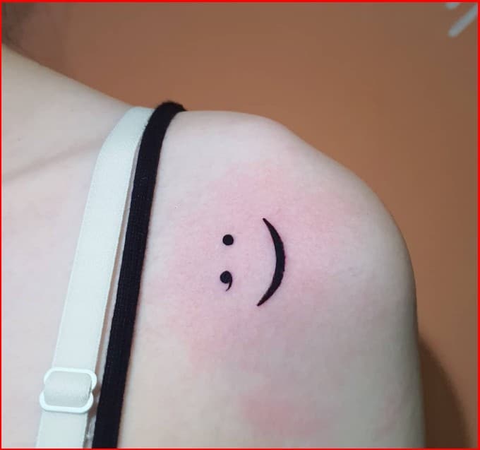 semicolon smiley tattoo on shoulder
