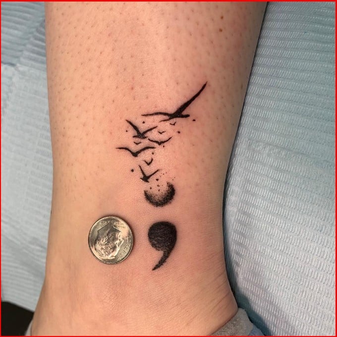 small bird semicolon tattoo
