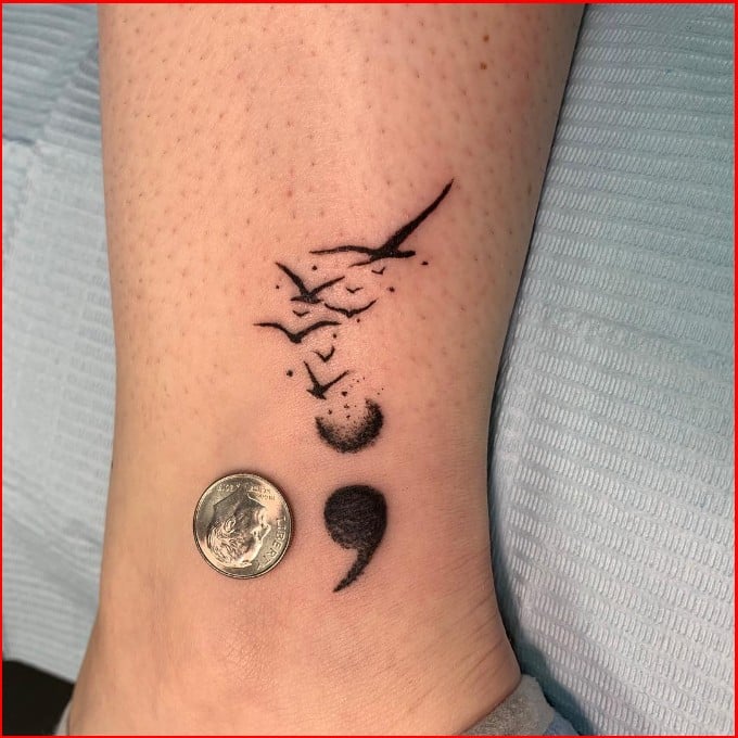 small bird semicolon tattoo 