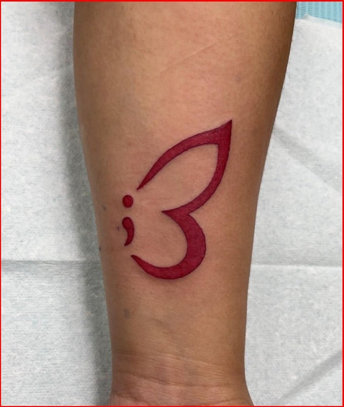 red color semicolon tattoos on arm