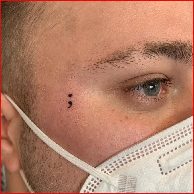 small semicolon tattoos on face