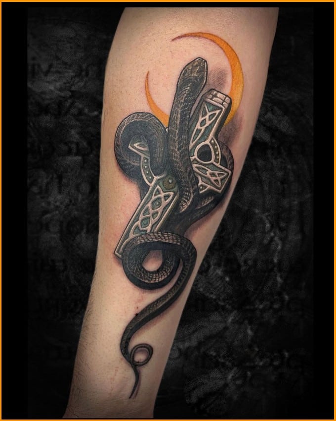 cross tattoos on arms with snake
