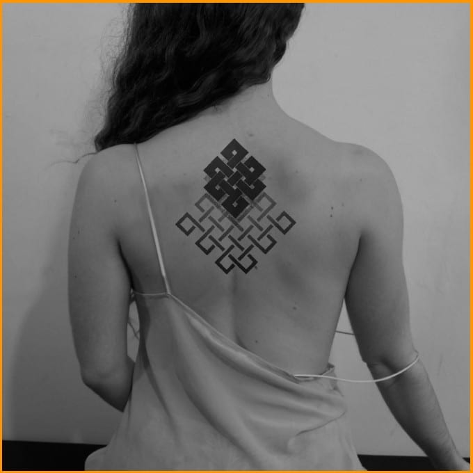 endless knot spiritual tattoo on back