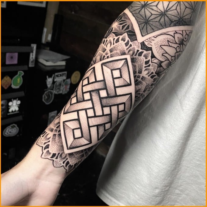 endless knot spiritual tattoos on arms