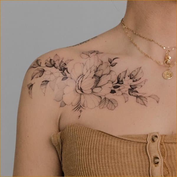 FIne line flower tattoo on the collarbone