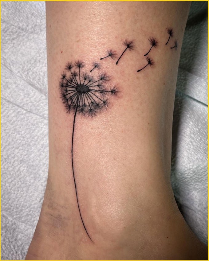 blowing dandelion tattoo