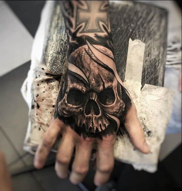 small skull hand tattoos