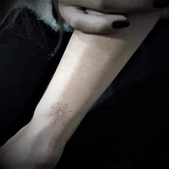 small sun tattoo for wrsit