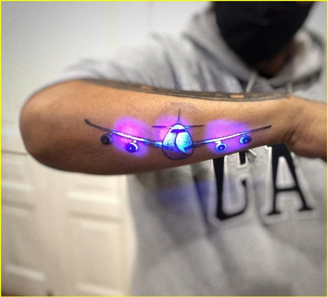 aeroplane uv ink tattoos on forearm