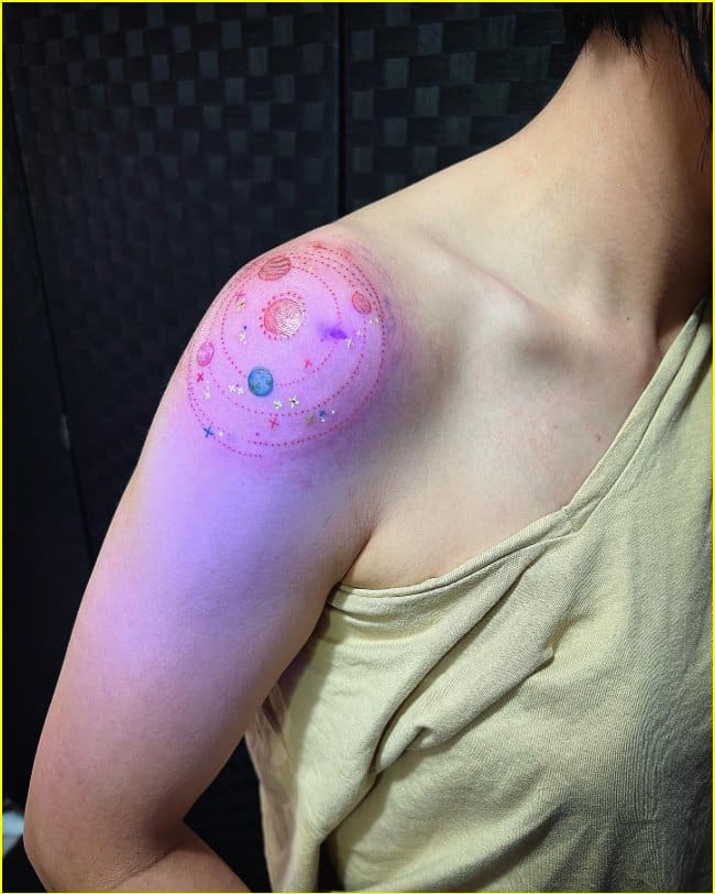solar system uv tattoo on shoulder