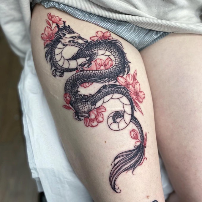 cherry blossom tattoo with dragon on thigh