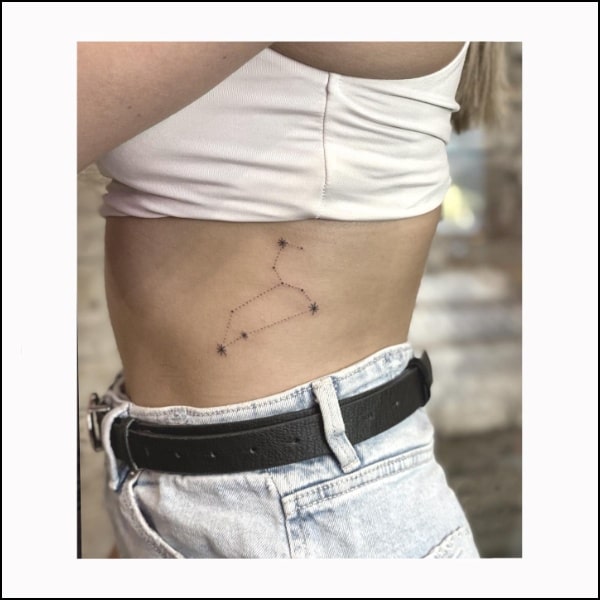 Leo constellation tattoo on the side rib for women