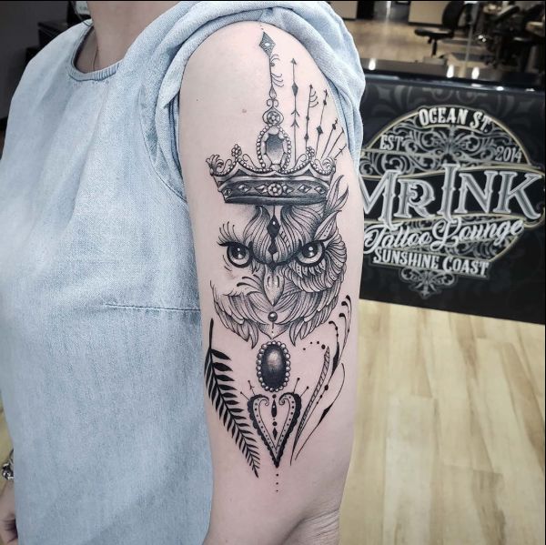 owl head with crown tattoo