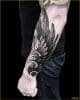 wing tattoo on arm