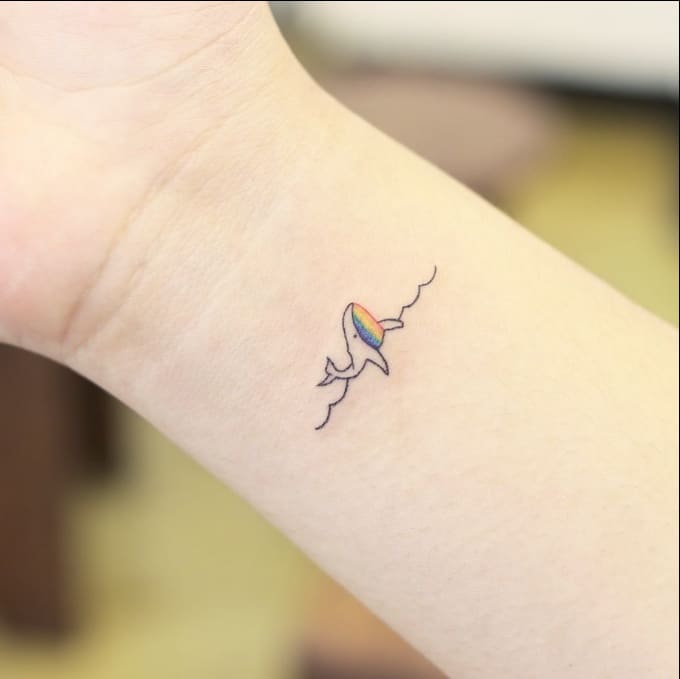 Small whale tattoo on the wrist